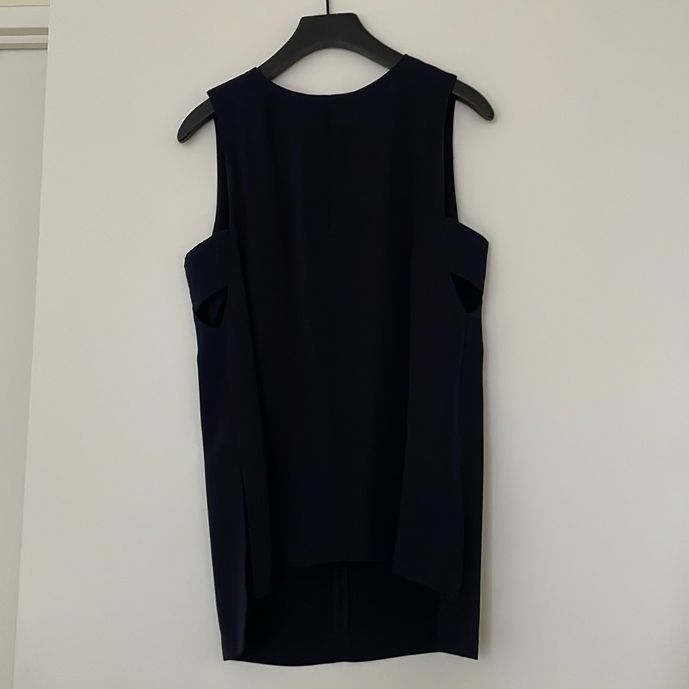 Sleeveless tunic with side cut-outs.